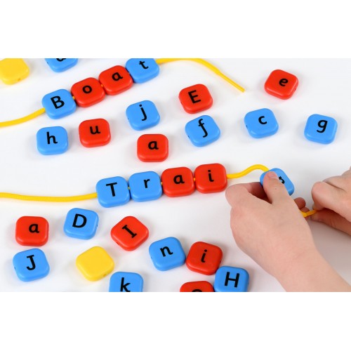 Colorful alphabet letter beads for lacing, with hand threading a bead