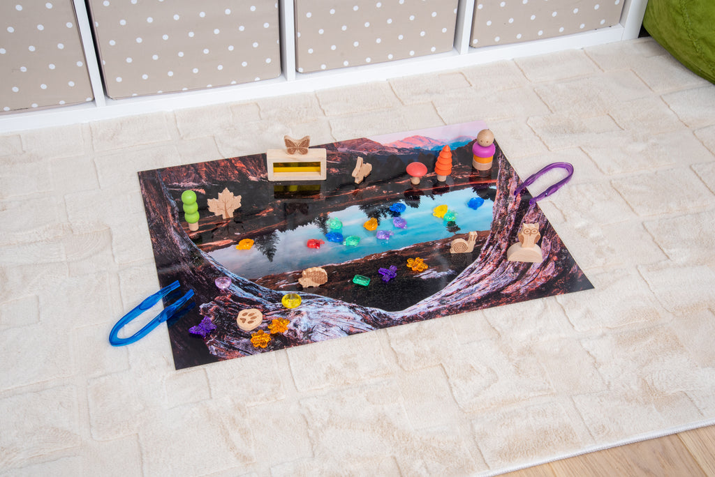 Kids’ play mat with colorful lake scene artwork and toys on the surface