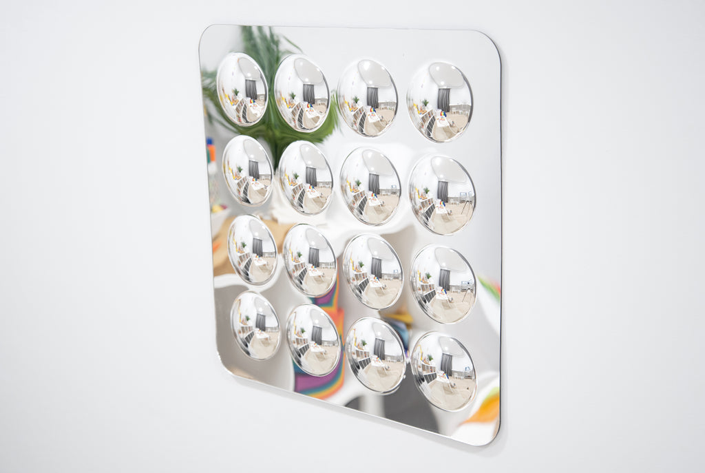 Large acrylic mirror panel featuring 16 domed round mirrors on white frame