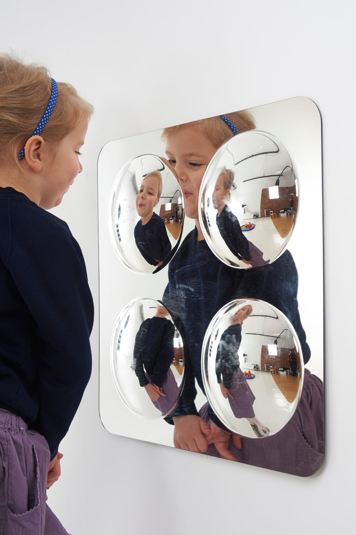 Large 4-dome acrylic mirror panel showing four reflective domes and people in view