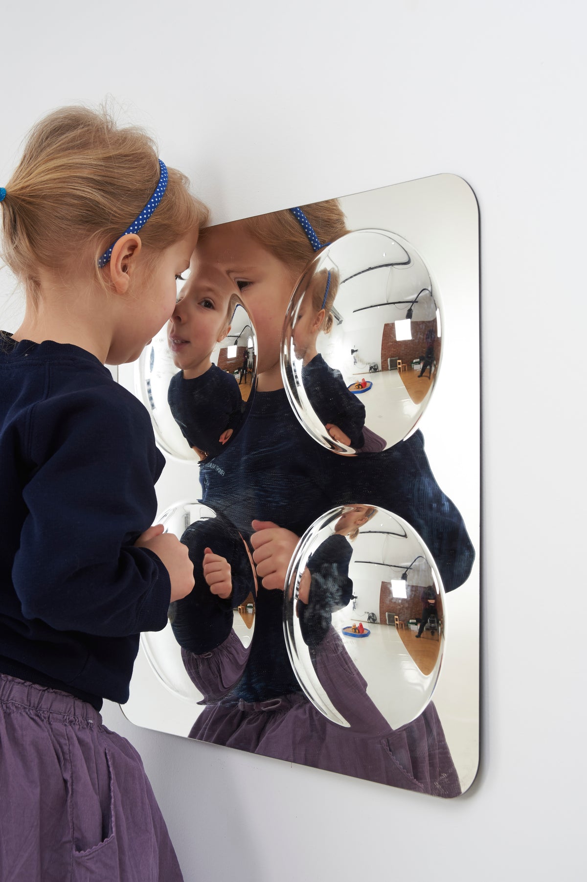 Large 4-dome acrylic mirror panel mounted on a surface with four convex domes