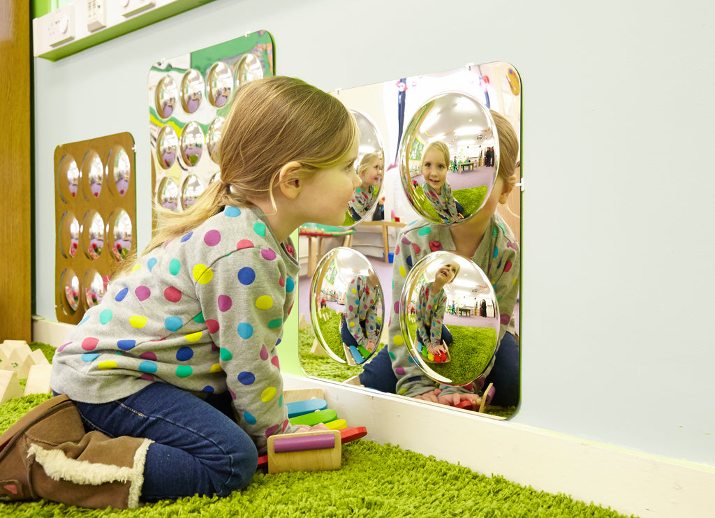 Large 4-dome acrylic mirror panel with four reflective domes and a child in the reflections
