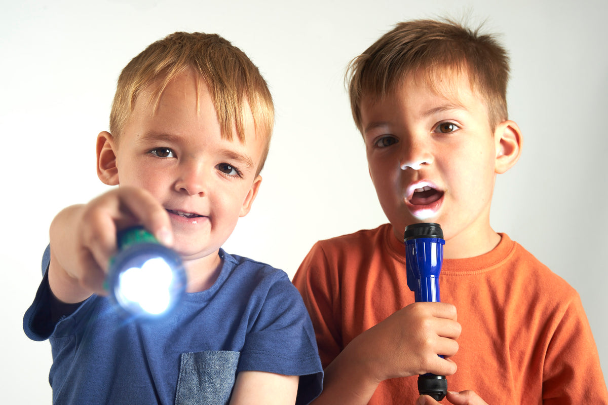 Handheld LED torch with glowing white light, blue body held near children's faces