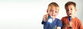 Pair of handheld LED torches with bright white beams, children holding them up