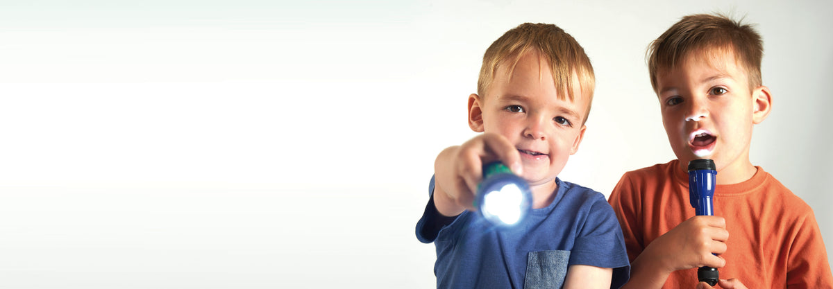 Pair of handheld LED torches with bright white beams, children holding them up
