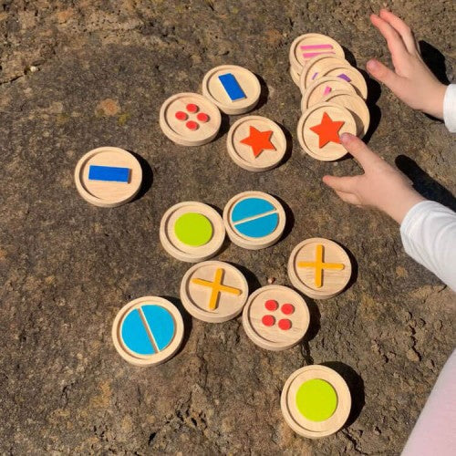 Round tactile discs on stone, featuring blue, green, red star and plus icons
