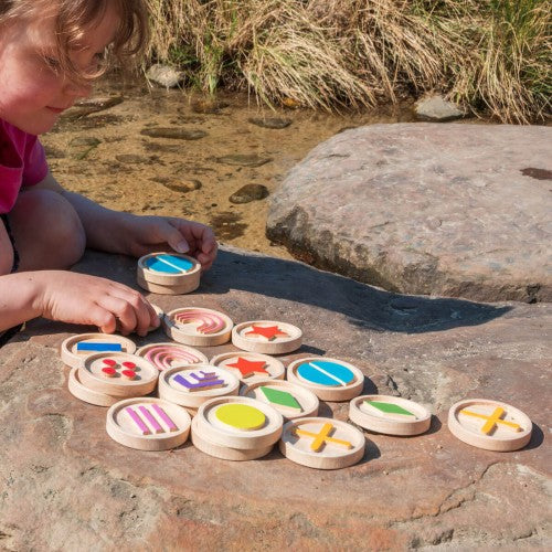 Tactile wooden discs with bright icon faces, round sensory pieces for play