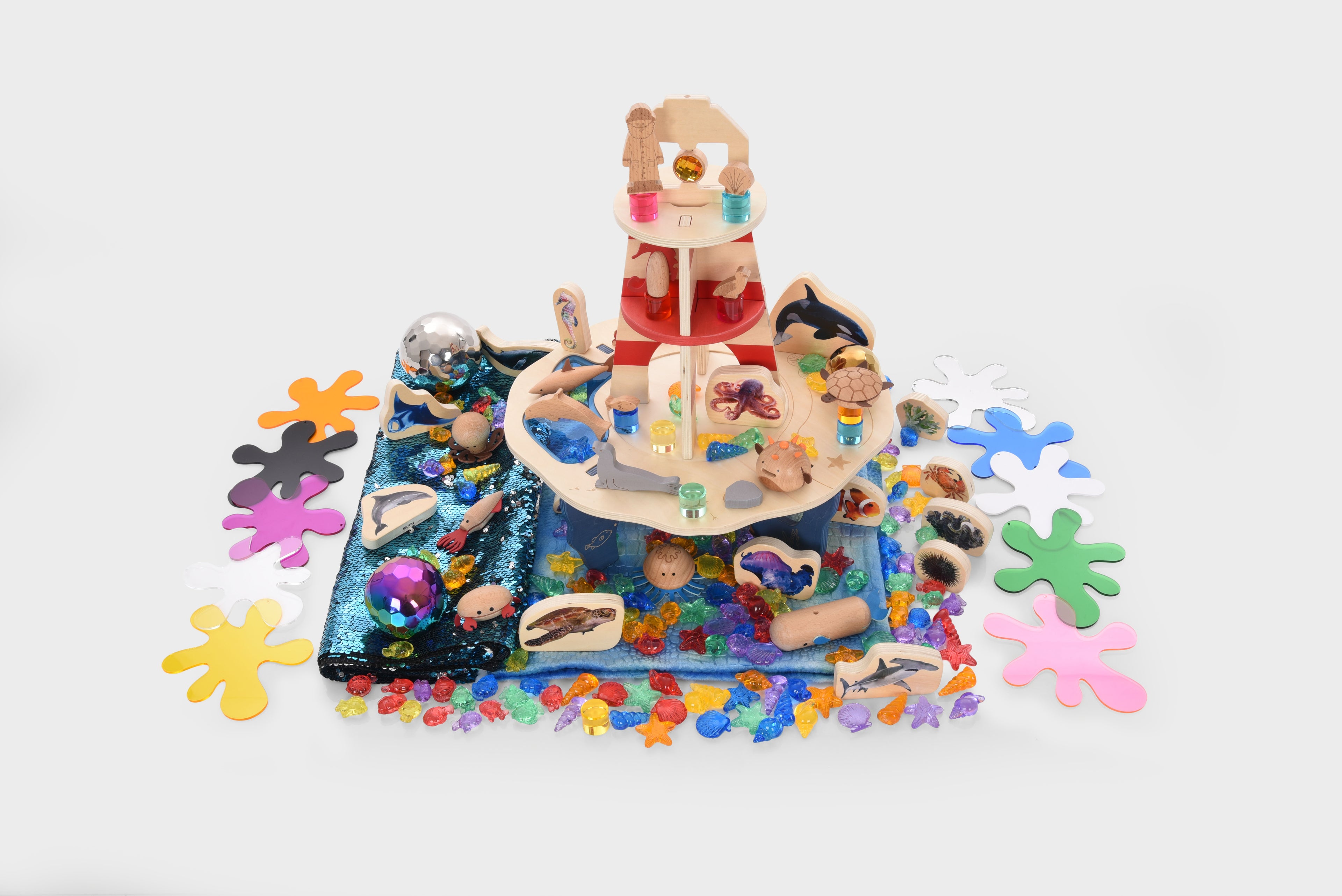 Colorful lighthouse toy bundle with stacked pieces and small ocean-themed figures