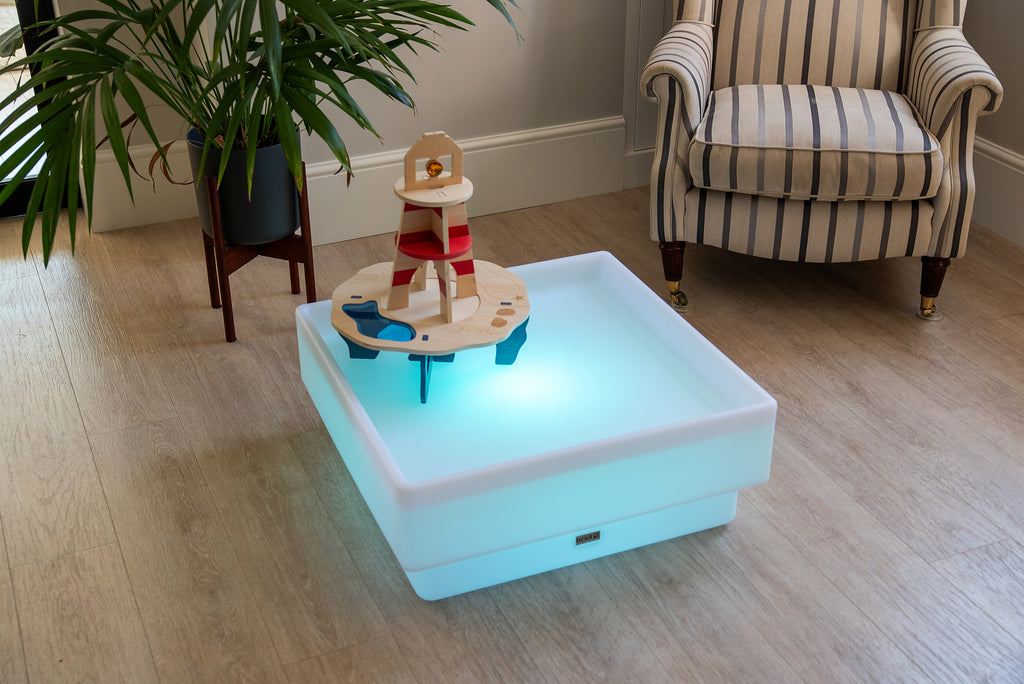 Light-up wooden water tray with lighthouse tower and sea animals, front corner view