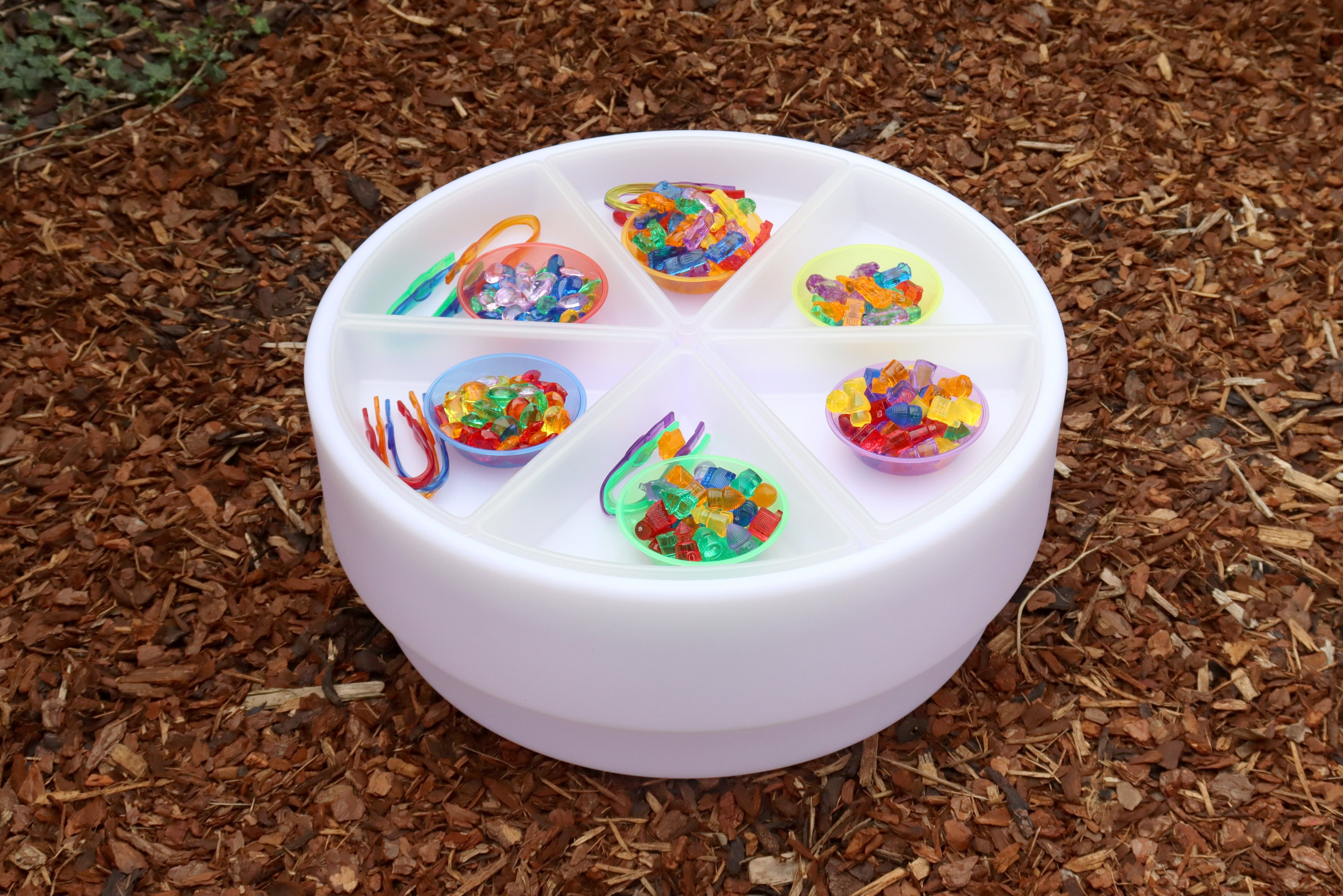 Top view of white round sorting tray with colorful bead piles