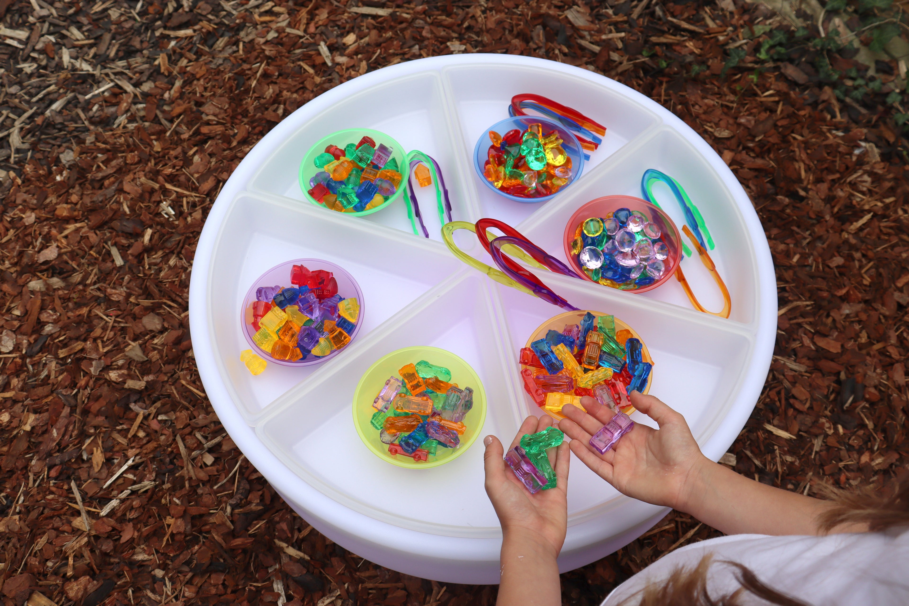 Round white spinner tray with small multicolor bead collections