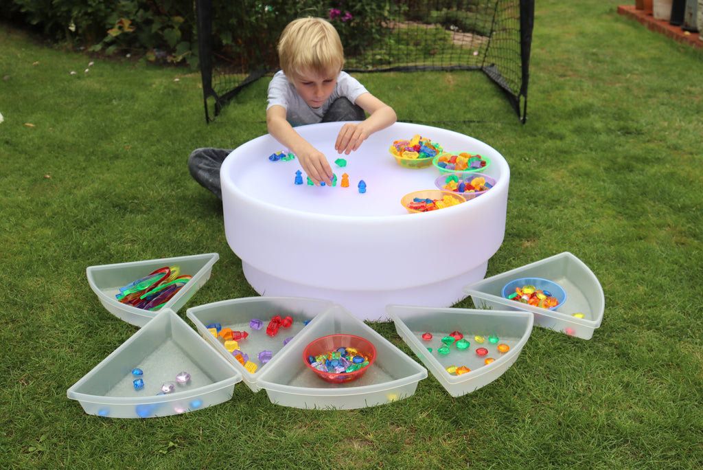 White sorting bowl and open side trays filled with colorful bead pieces