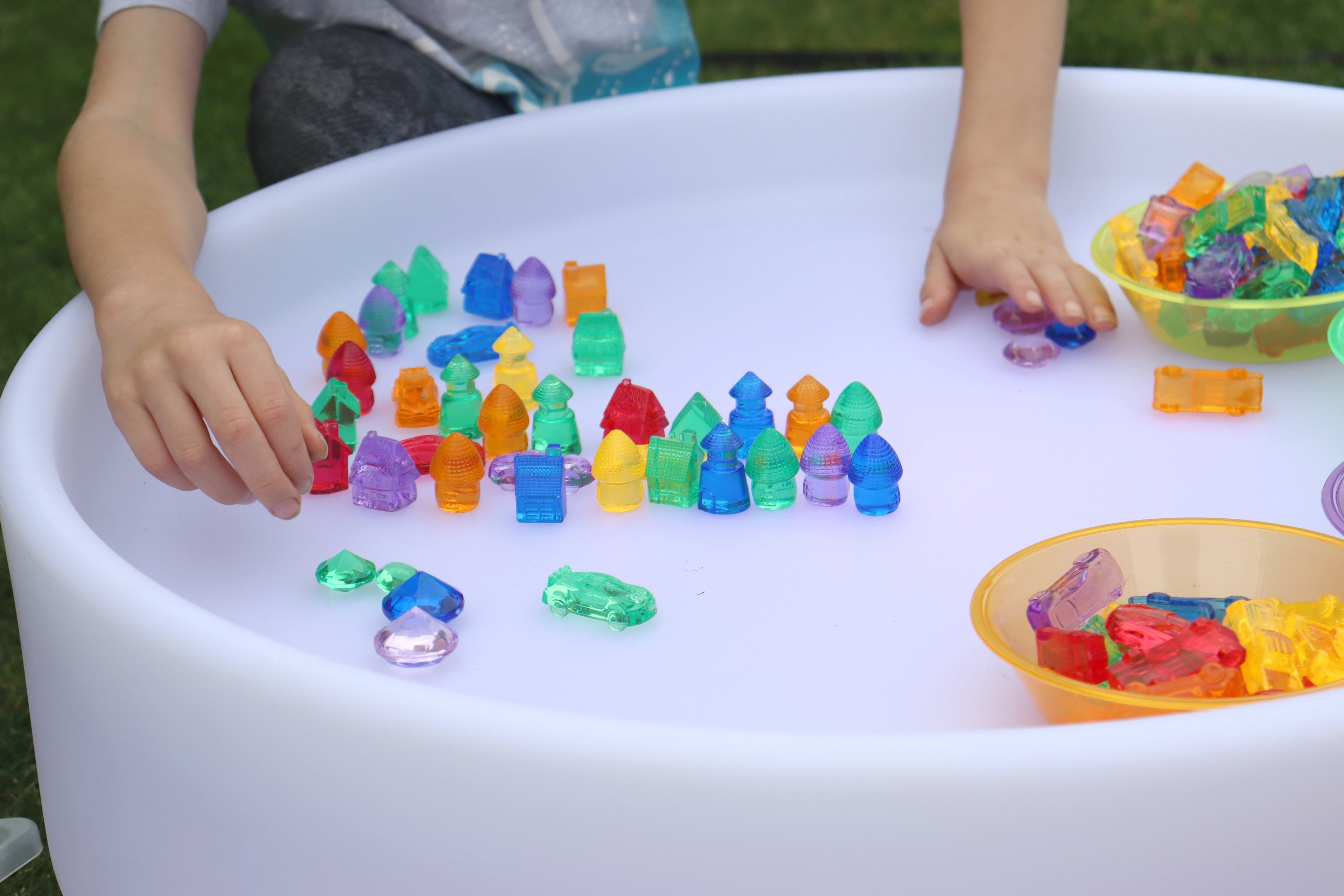 Large white sorting bowl with colorful bead pieces and trays