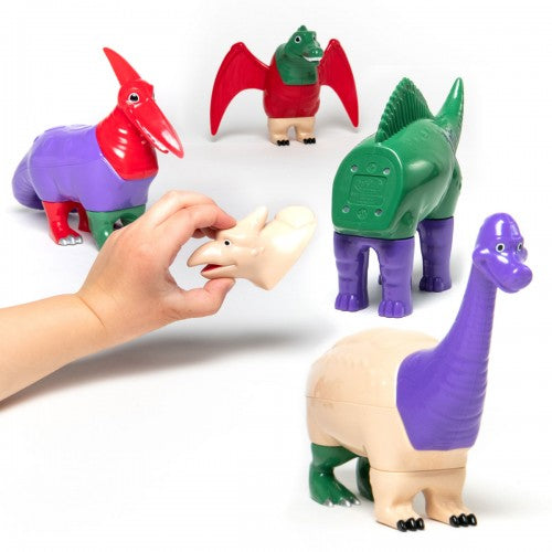 Colorful plastic dinosaur figures set, with a white dinosaur being held