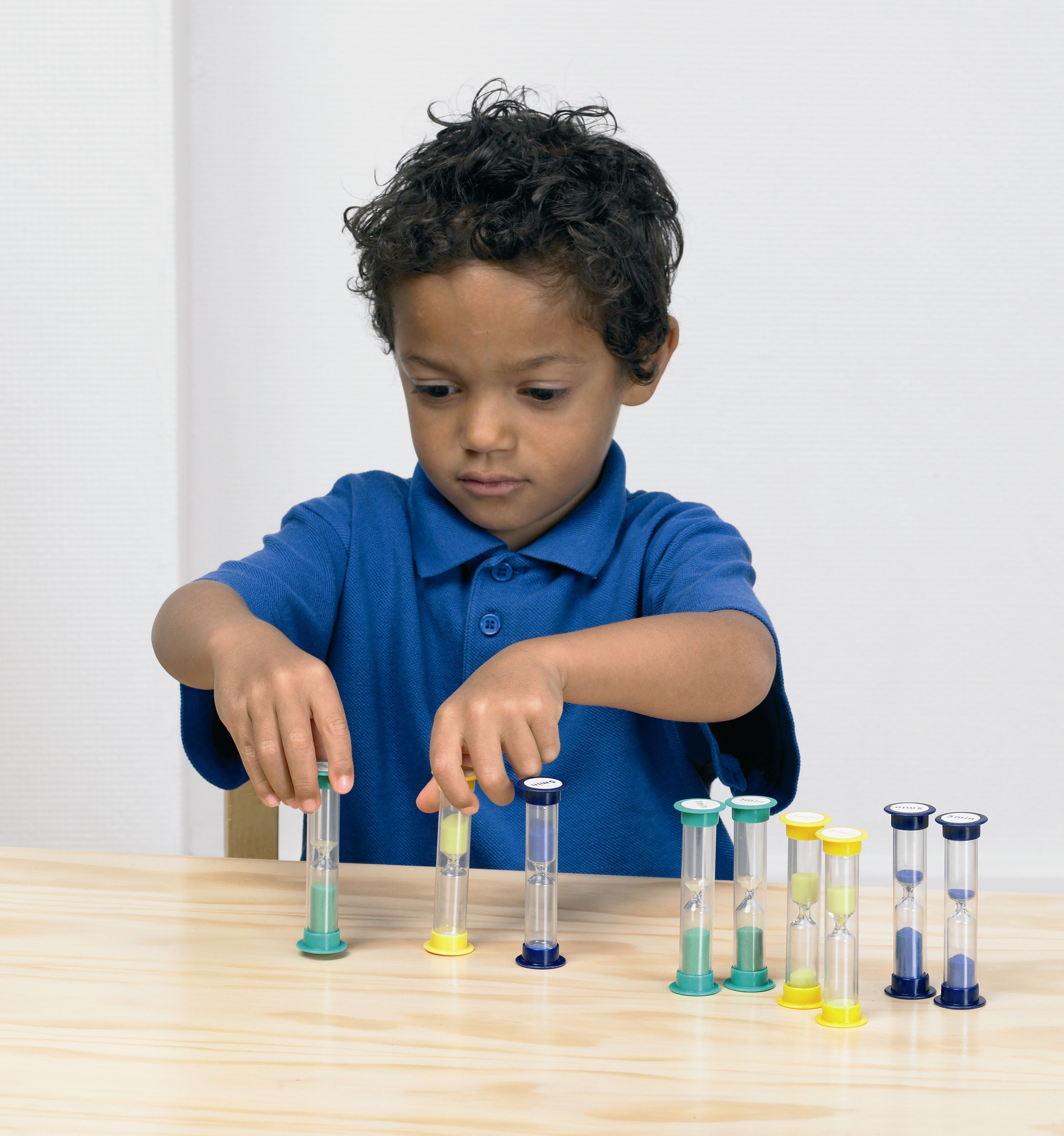 Mini sand timers with blue caps and colorful bases, multiple hourglasses lined up