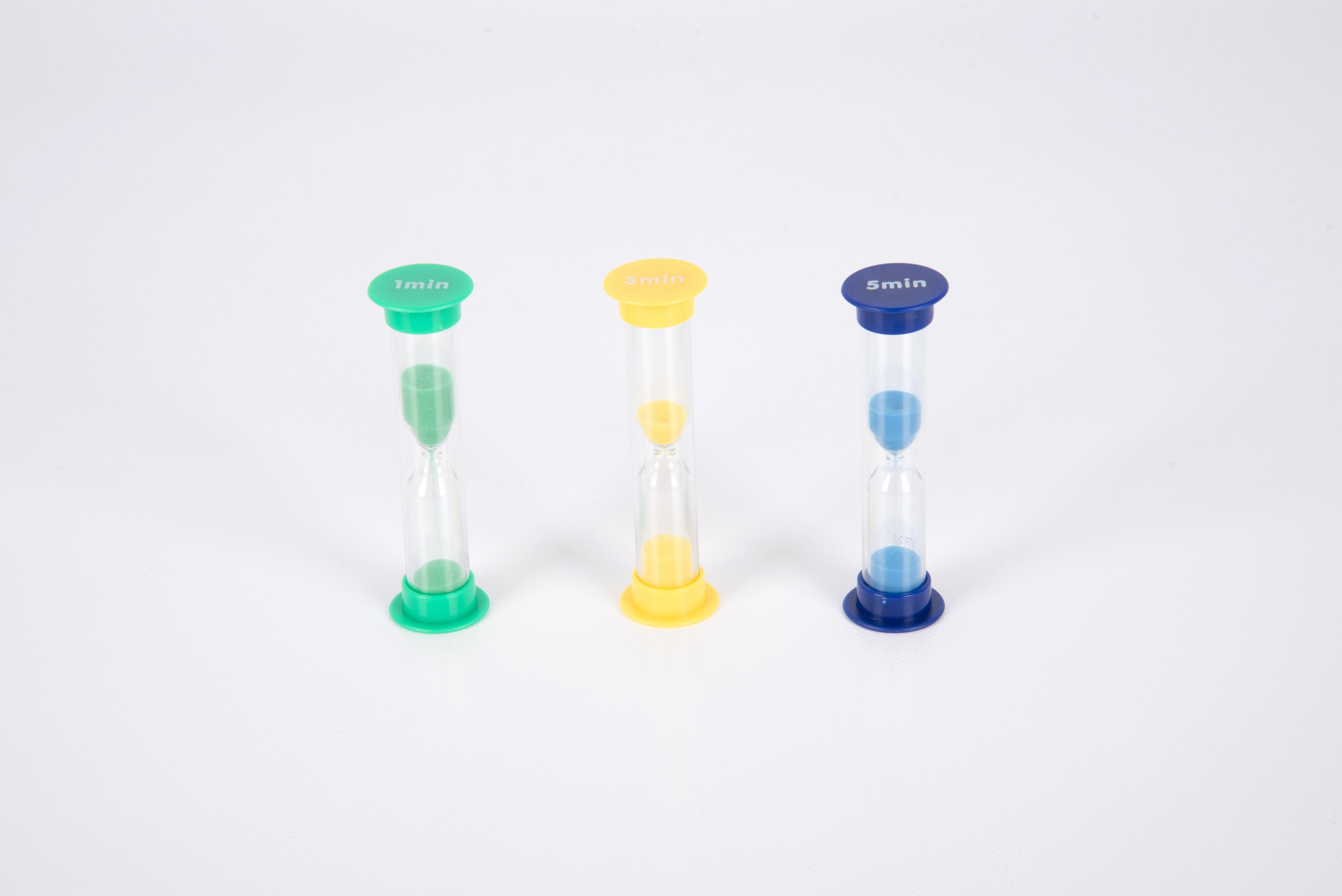 Mini sand timer trio on white: green, yellow, and blue hourglasses