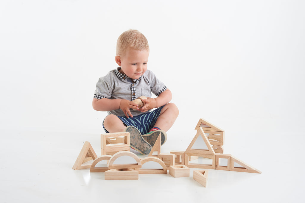 Wooden construction blocks with house and arch forms and assorted cutouts