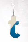 Lowercase mirrored letter ornament in beige and blue, hanging by a string