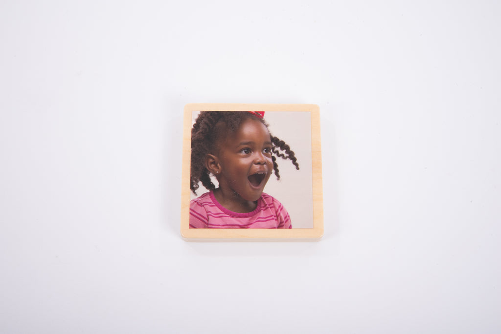 Single wooden photo tile with a child portrait in a square frame