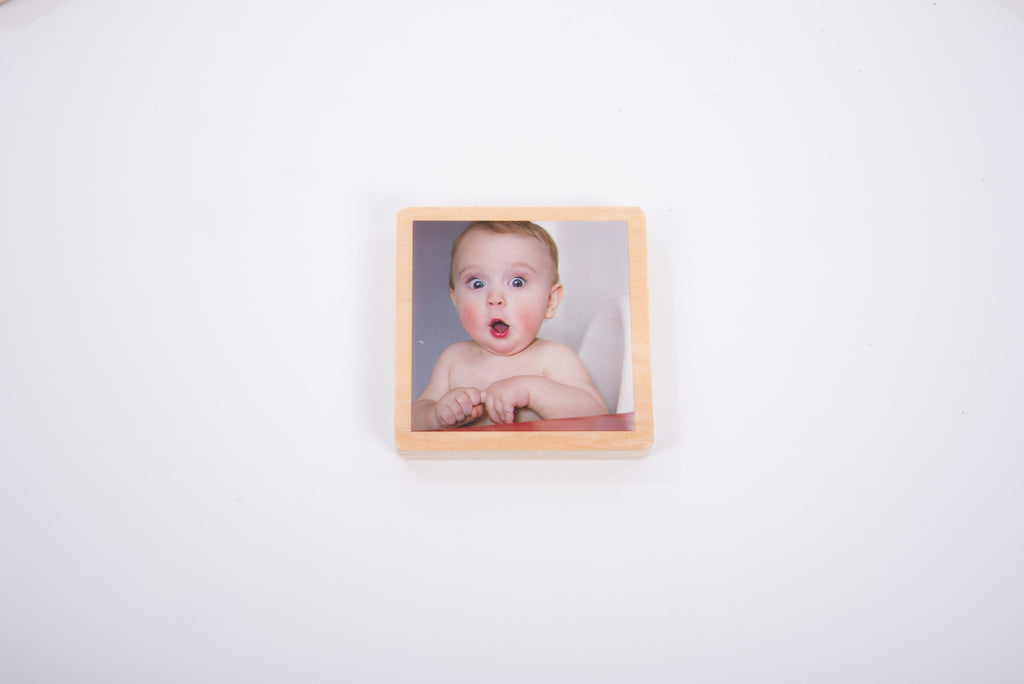 Single wooden photo tile with a baby portrait in a square frame