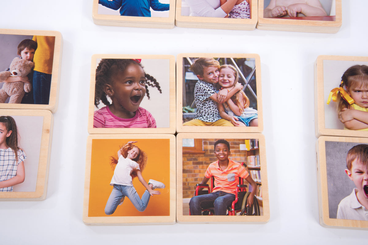 Wooden photo tiles with multiple children portrait photos, shown in close-up arrangement
