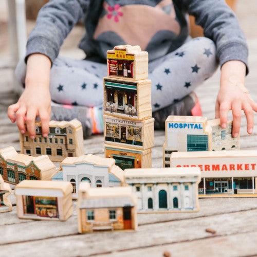 Wooden miniature town building set with stacked storefronts and houses