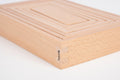 Light wood building block with engraved corner mark and smooth panel grooves