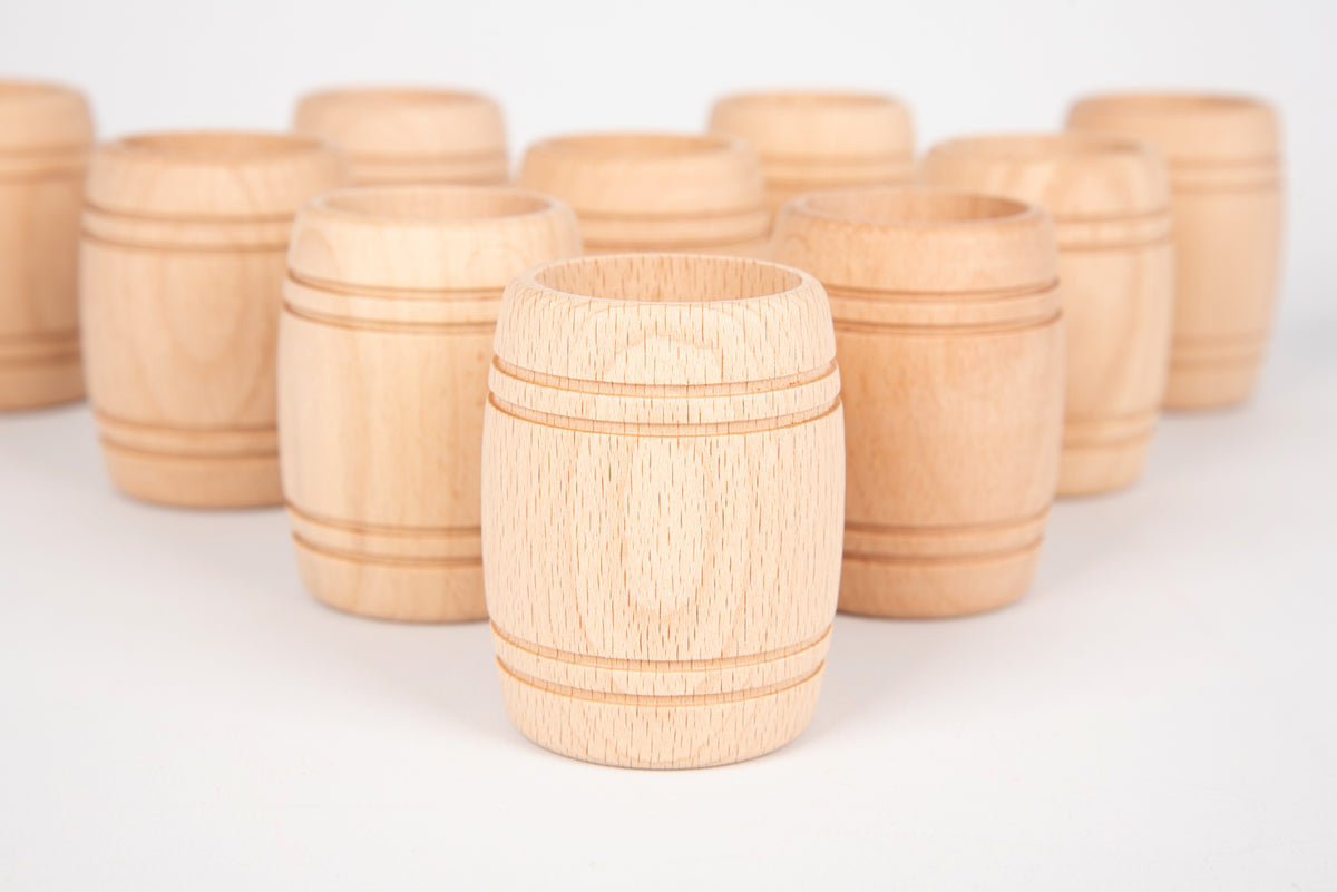 Natural wooden barrel-shaped cups, one foreground with carved wood grain bands