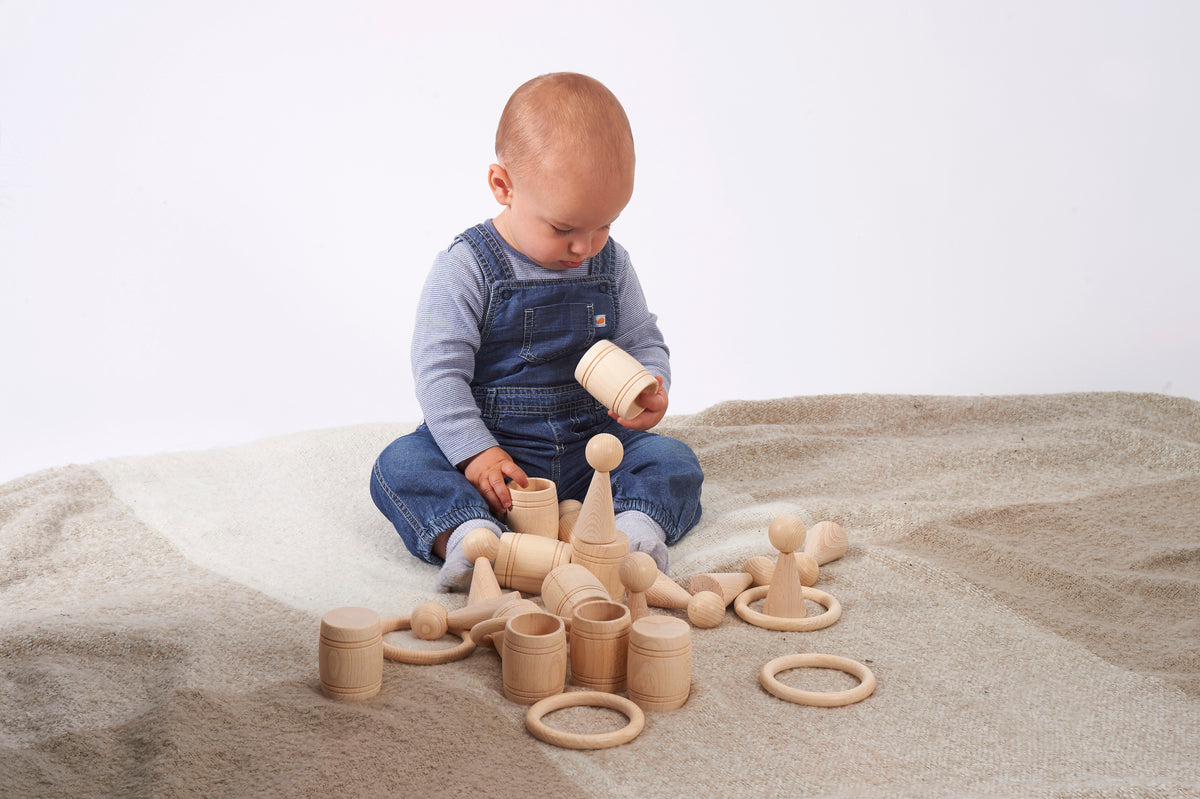 Natural wooden barrel toys with loop rings, toddler arranging pieces