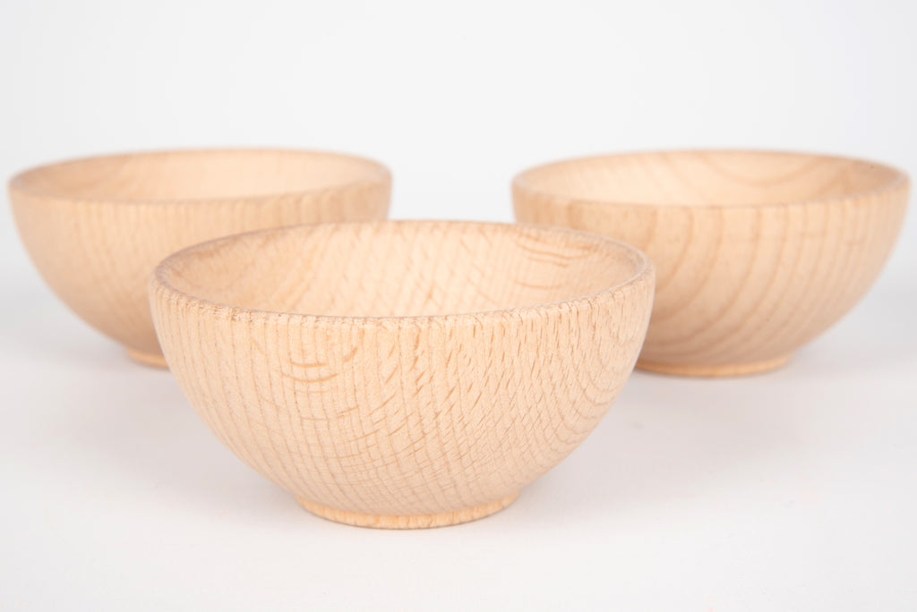 Three natural wooden bowls, one front bowl and two back bowls visible