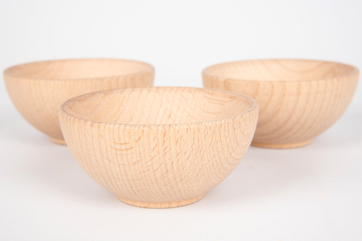 Three natural wooden bowls, one front bowl and two back bowls visible