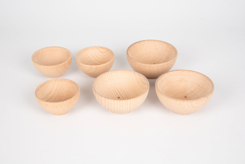 Natural wooden bowls set, six small bowls arranged in a row