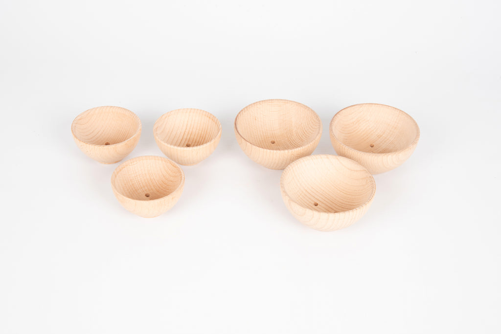 Assorted natural wooden bowls, five small bowls arranged for display