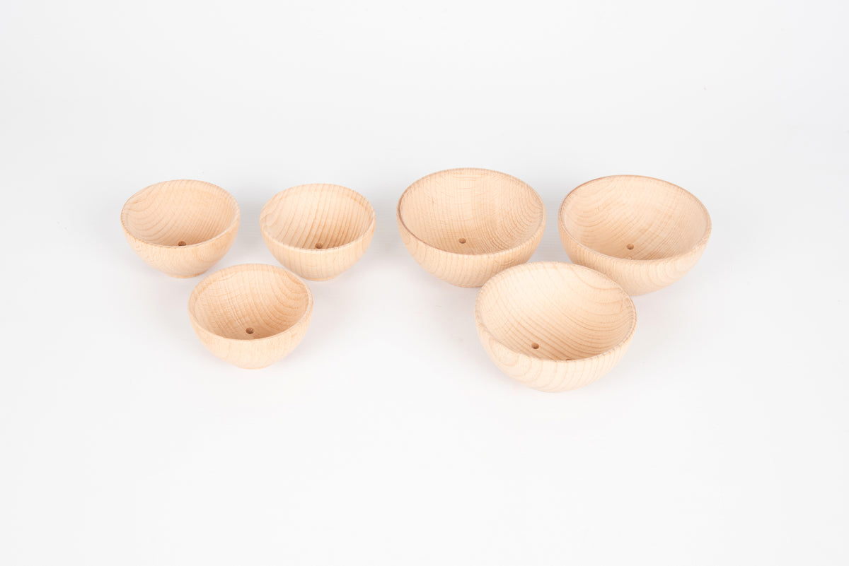 Assorted natural wooden bowls, five small bowls arranged for display