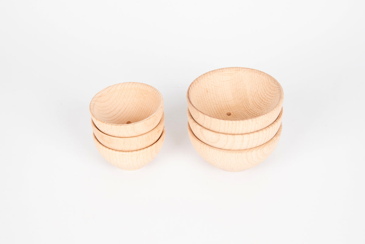 Set of natural wooden bowls with two bowls stacked and two bowls shown