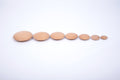 Set of 7 natural wooden buttons, light tan round discs arranged in a line