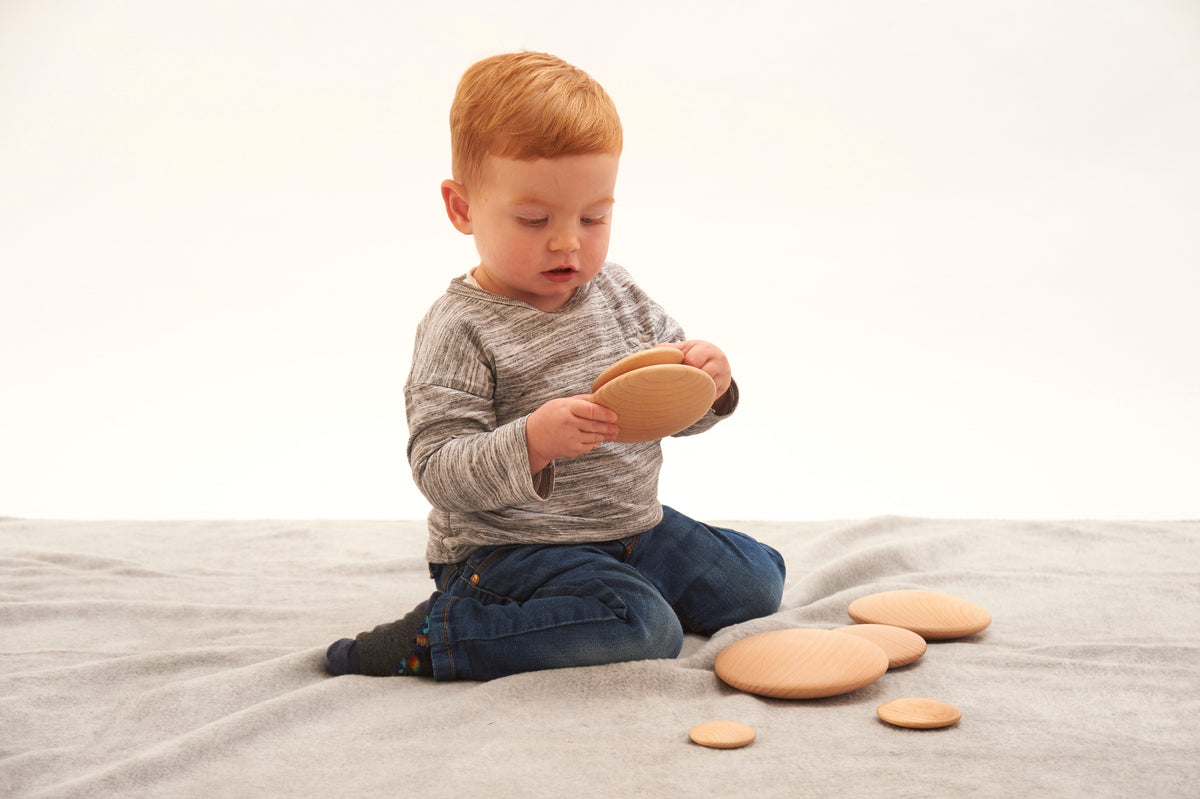 Light tan natural wooden buttons set of 7, round discs on fabric