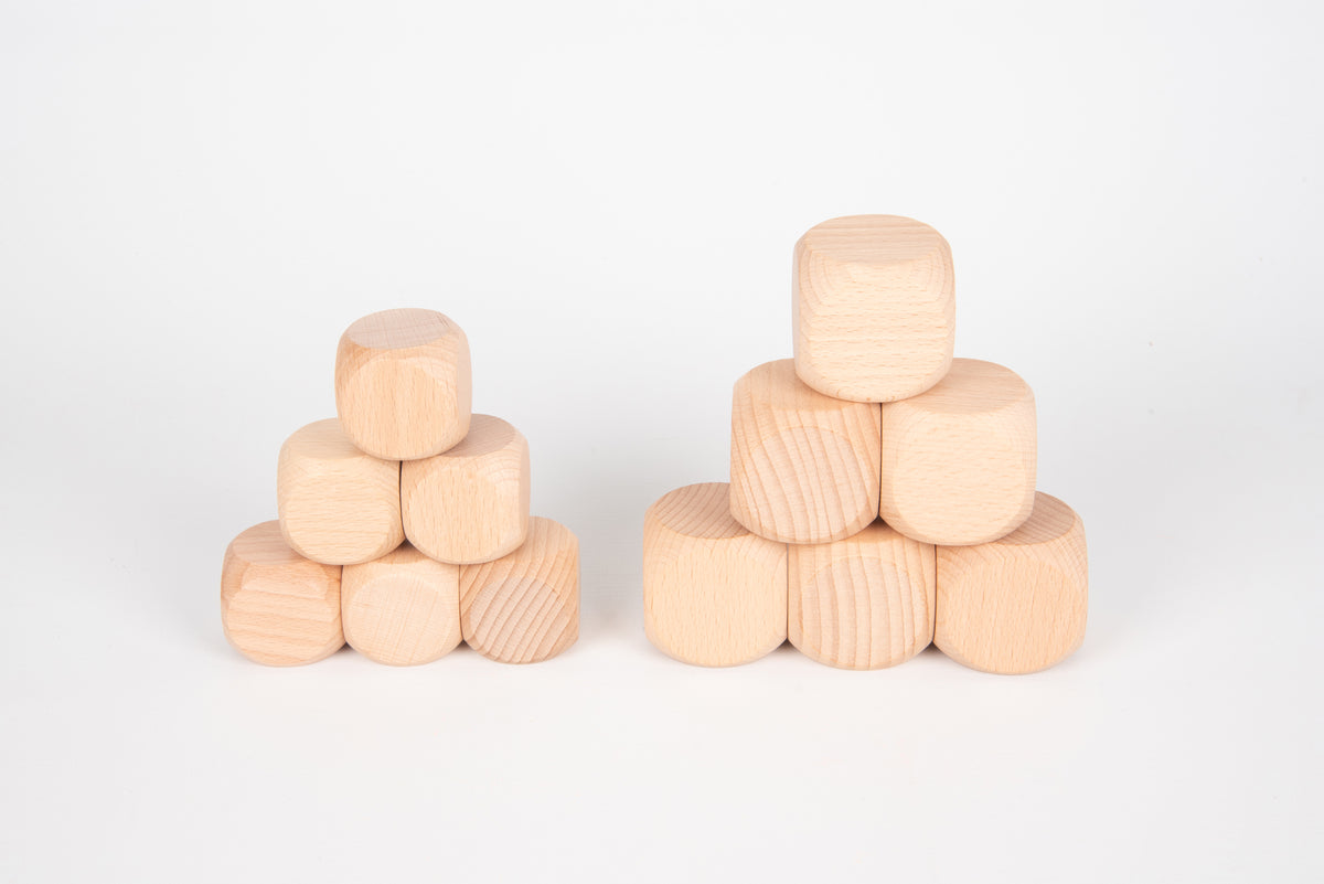Natural light wood cube blocks, arranged in two small stacks