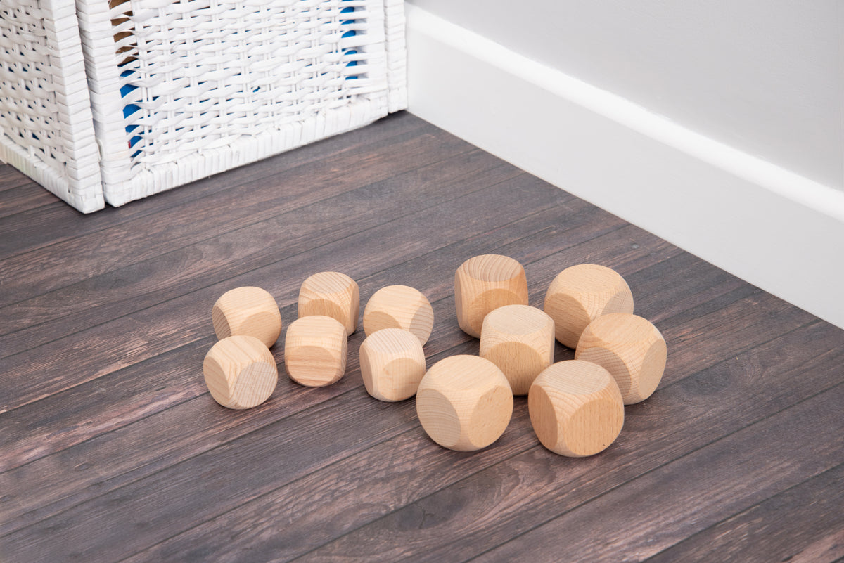 Natural light wood cube blocks on a dark wooden floor