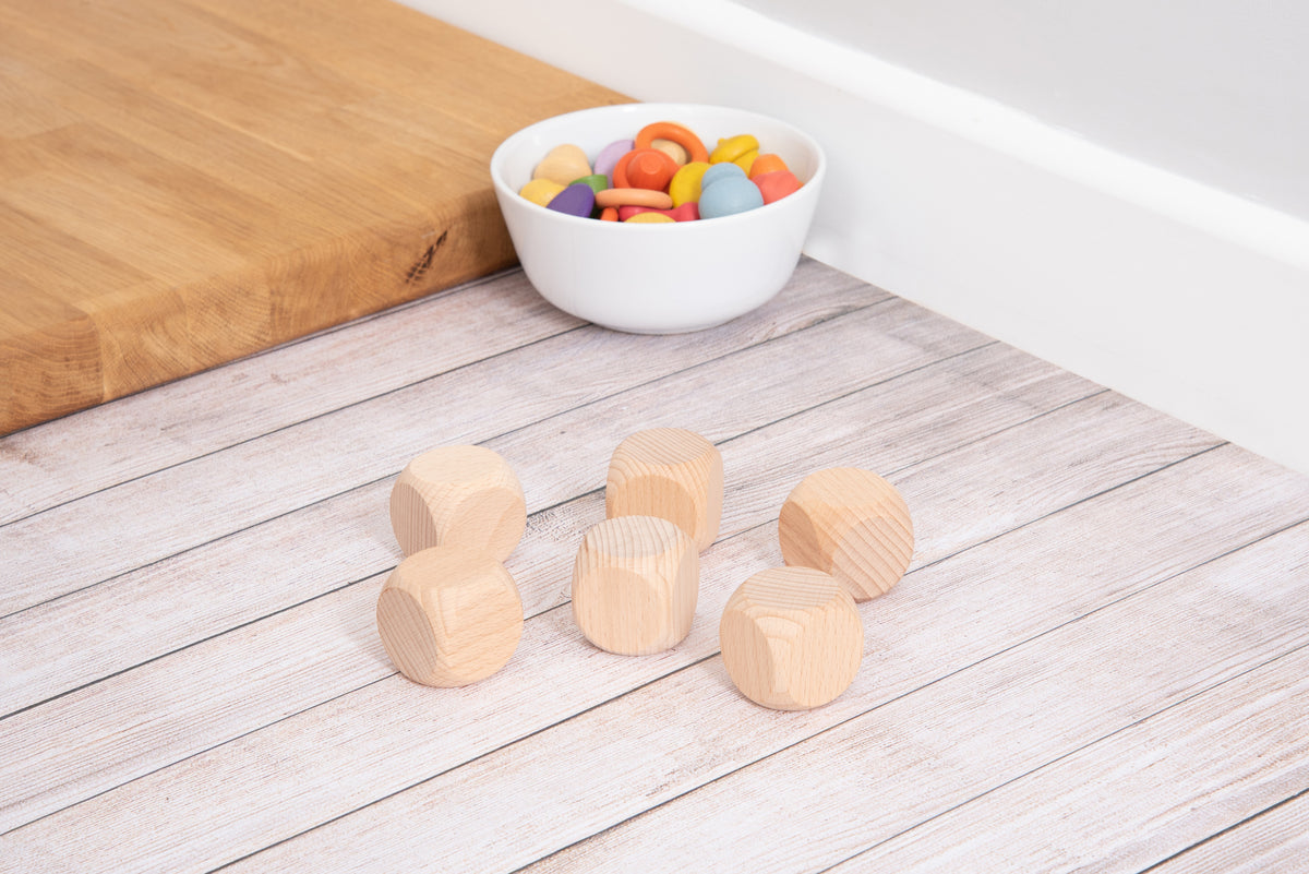 Natural light wood cube blocks on a light wooden surface