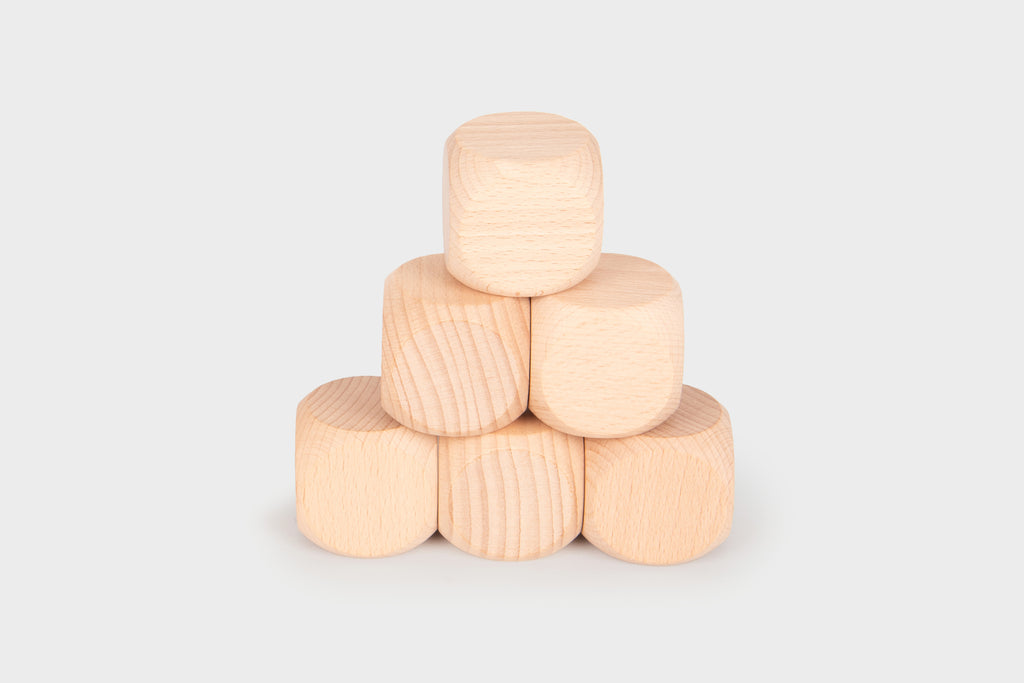 Natural light wood cube blocks, stacked in a small pyramid shape