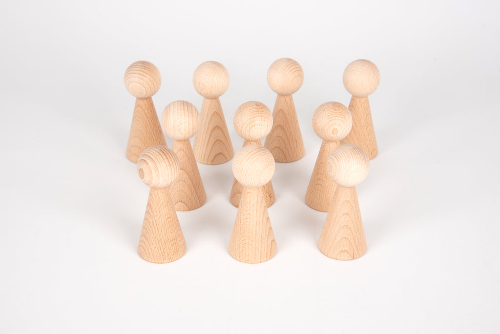 Multiple natural wood peg figures standing upright with smooth rounded heads