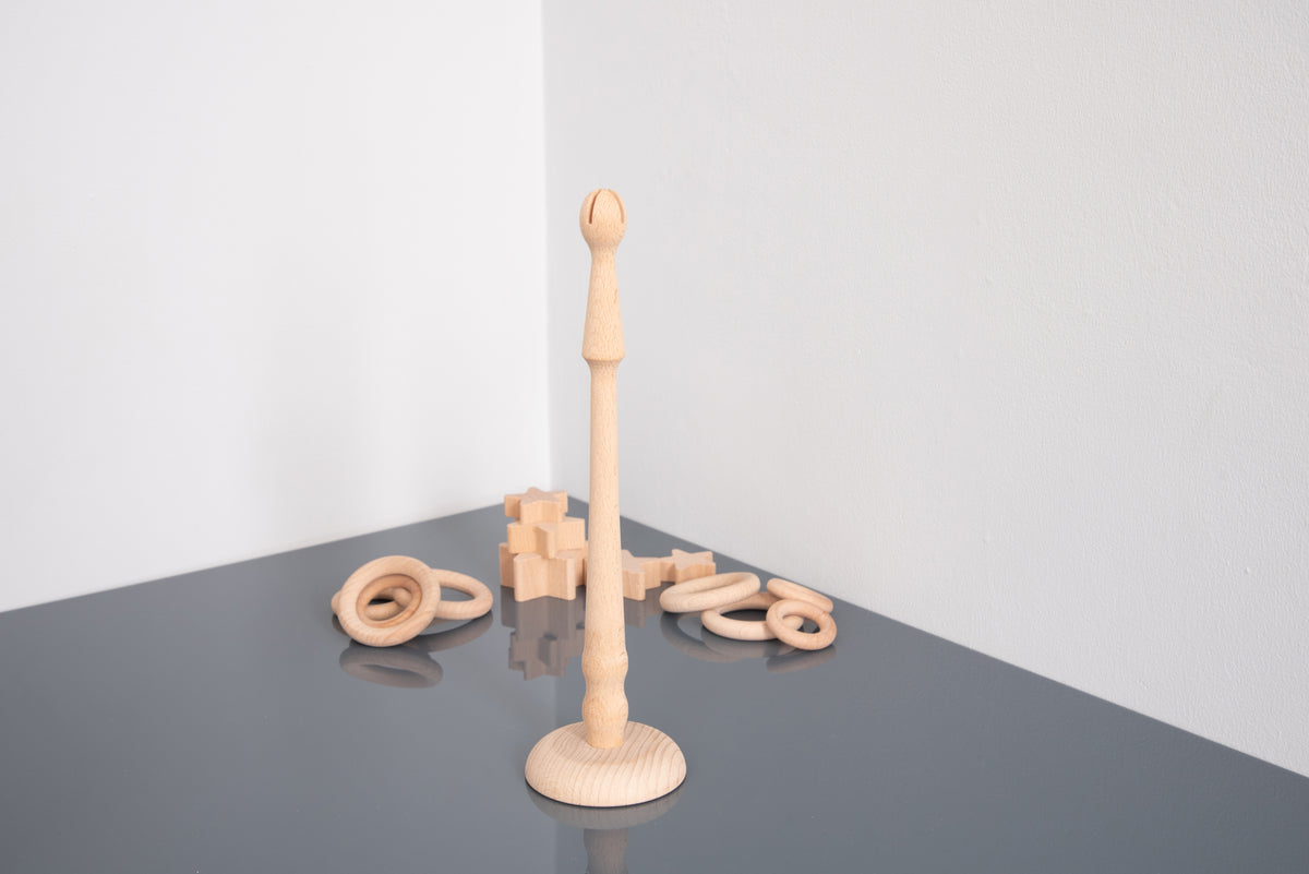 Light wooden ring stand with upright peg, shown with rings and small star blocks