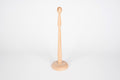 Natural wooden ring stand with round base and upright peg for displaying rings