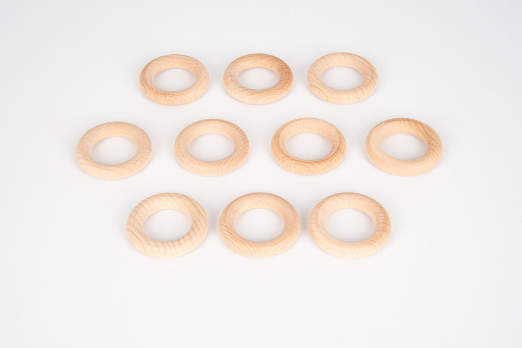 Natural wooden ring set, light pine-colored 56 mm rings arranged on a white surface