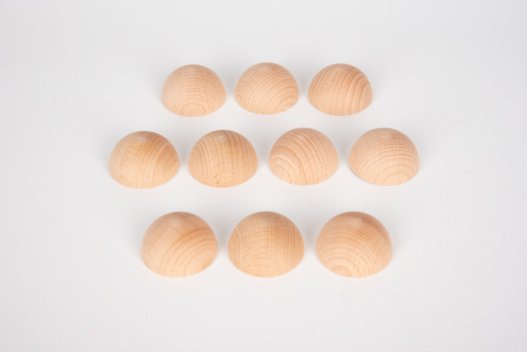 Natural wooden semispheres, light tan domes arranged in a row and grid
