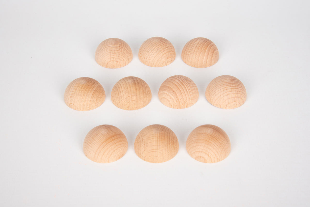 Natural wooden semispheres, light tan domes arranged in a row and grid