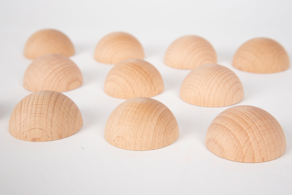 Natural wooden semispheres, light tan domes showing wood grain lines