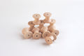 Set of natural wooden thread spools, round bobbins with central holes.