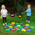 Set of colorful crab-shaped lawn toys in bright red, blue, green, and yellow
